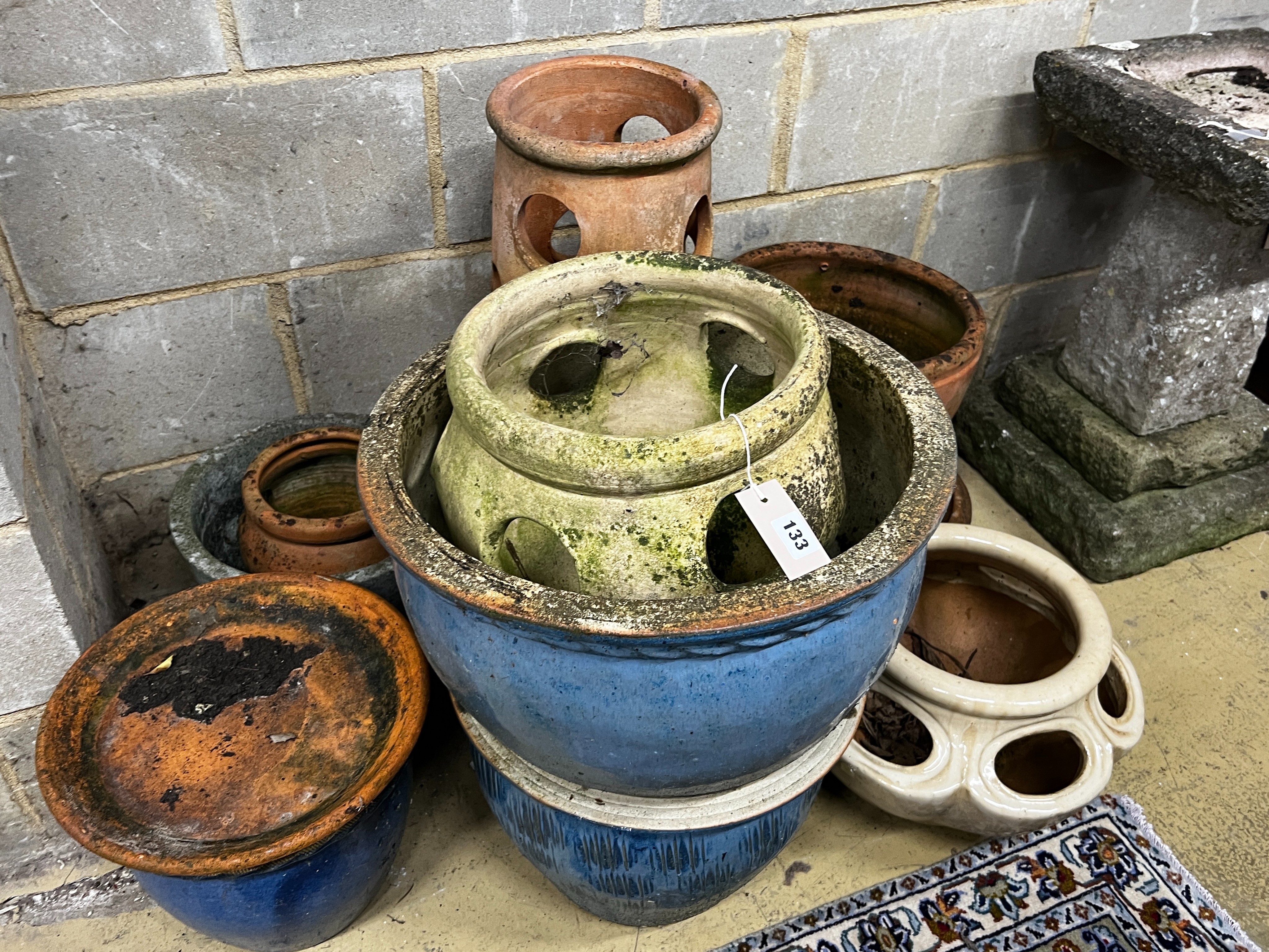 Ten assorted terracotta and glazed earthenware garden planters and three saucer bases, largest diameter 46cm, height 29cm